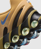 Close-up of tan sneaker with blue swoosh, black mesh, visible air cushioning and Patta logo
