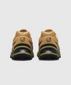Rear view of tan and olive green Air Max sneakers on a white background