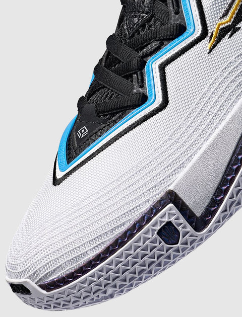 Close-up of a men's white and black sneaker with textured mesh, blue and gold accents, and detailed sole.