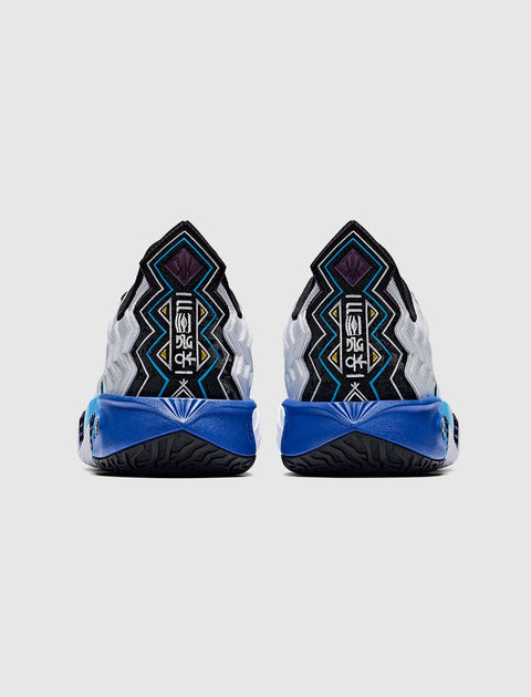 Men's sneakers with bold geometric patterns, blue soles, and black and white details, rear view
