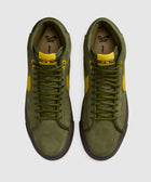 Olive green high-top suede sneakers with yellow accents, viewed from above