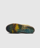 Sneaker with translucent sole featuring yellow, black, and blue marbled pattern on white background
