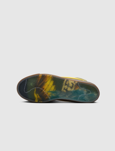 Sneaker with translucent sole featuring yellow, black, and blue marbled pattern on white background