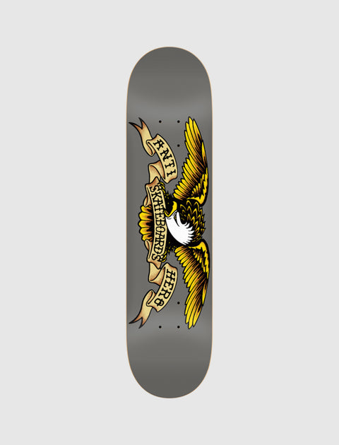 Grey skateboard deck featuring a yellow eagle and vintage tattoo style banner graphic.