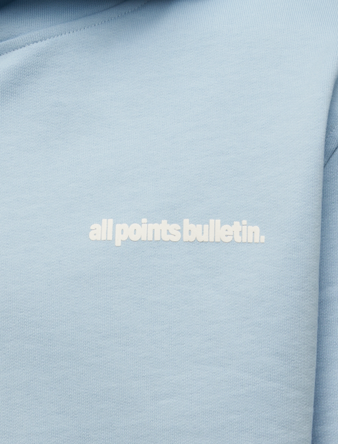 Light blue streetwear hoodie with white all points bulletin text on chest