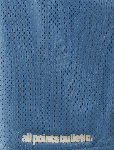 Blue mesh athletic shorts with 'all points bulletin.' white text near hem