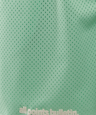 Green mesh athletic shorts with perforated fabric and 'all points bulletin.' text at the hem.