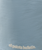 Light blue streetwear shirt with 'all points bulletin.' text design detail