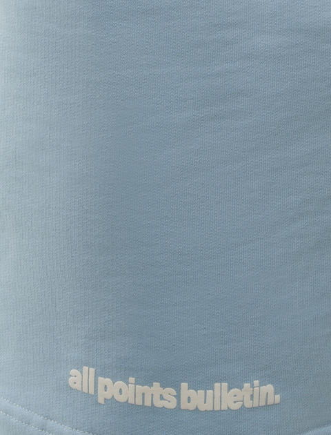 Light blue streetwear shirt with 'all points bulletin.' text design detail