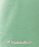 Mint green streetwear top with all points bulletin text in white lettering