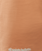 Peach pink streetwear t-shirt with all points bulletin text detail on hem