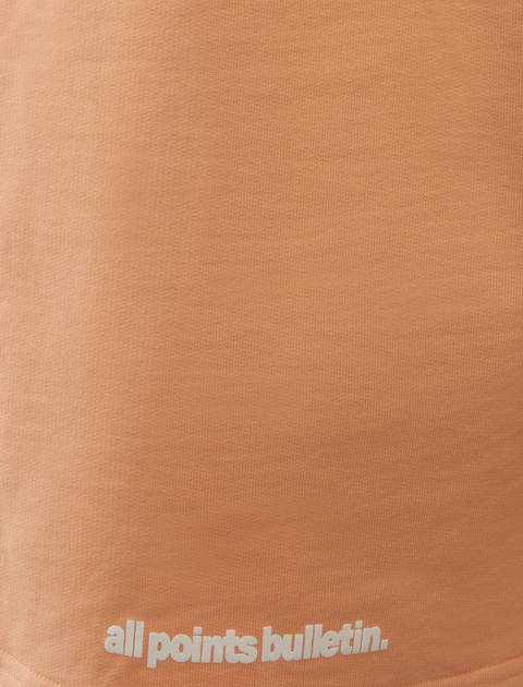 Peach pink streetwear t-shirt with all points bulletin text detail on hem