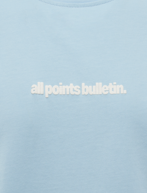 Light blue men's streetwear t-shirt with white embroidered all points bulletin text logo