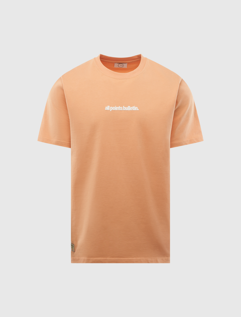 Peach short-sleeve streetwear t-shirt with 'all points bulletin.' text on front