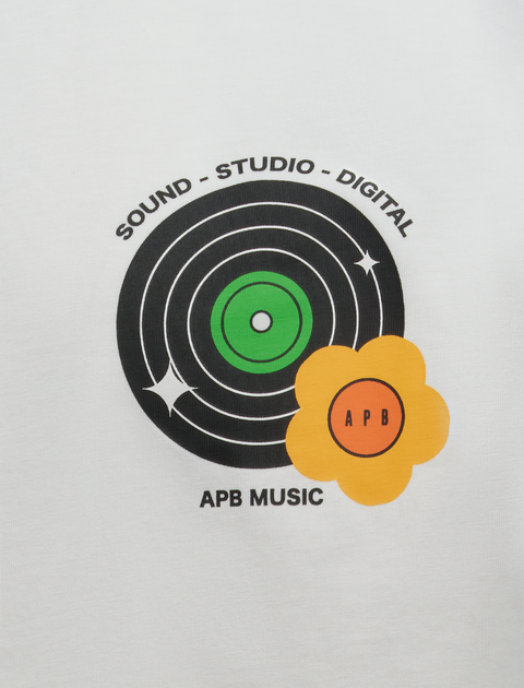 White streetwear tee with vinyl record graphic, green center, yellow flower, and APB MUSIC text