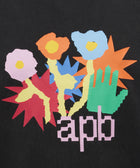 Colorful abstract flowers and green hand graphic with 'apb' text on black t-shirt fabric