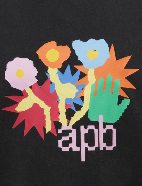 Colorful abstract flowers and green hand graphic with 'apb' text on black t-shirt fabric