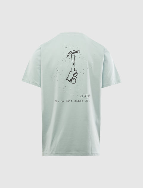 Light blue men's streetwear t-shirt with hand holding hammer graphic and bold back print.