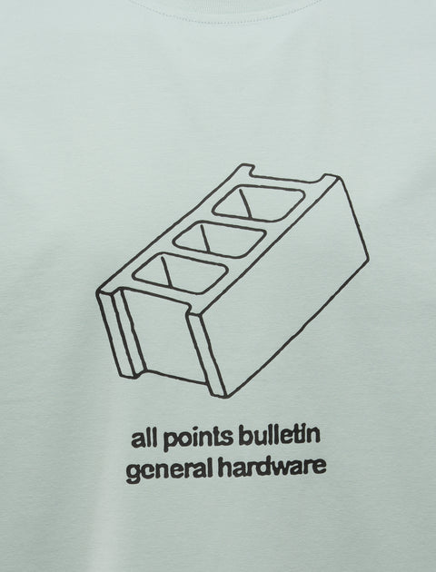 Light blue men's streetwear tee with black line art cinder block and text graphic on front