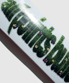 White skateboard deck with green grass and flower graphic lettering design