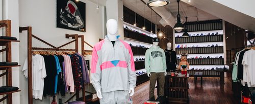 Men's streetwear shop interior with mannequins in trendy athletic apparel and sneakers