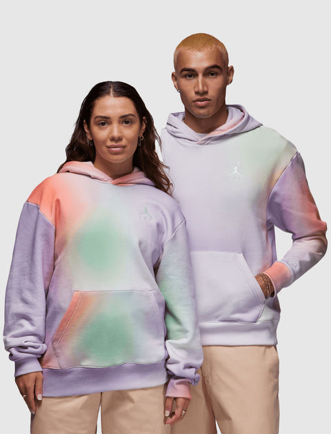 Two models wearing pastel tie-dye hoodies and beige pants, casual streetwear style.