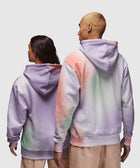 Two people wearing pastel tie-dye hoodies and beige pants, seen from the back