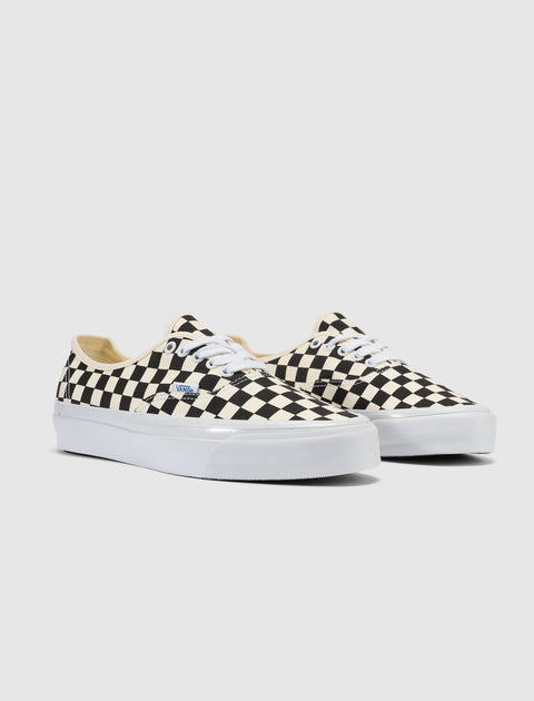 Black and white checkerboard canvas sneakers with white laces and rubber sole