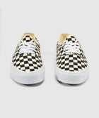 Black and white checkerboard canvas sneakers with white laces and rubber soles