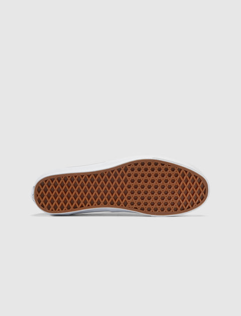 Gum waffle outsole of a classic low-top sneaker on a white background