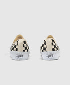 Back view of black and white checkerboard low-top canvas sneakers with white soles