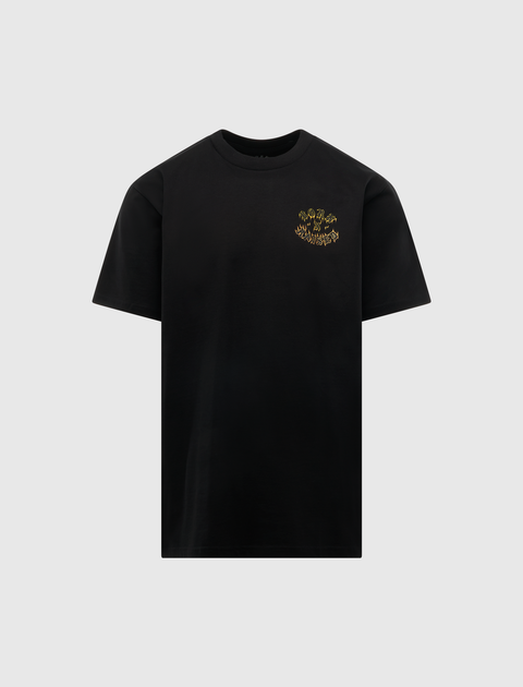 Black streetwear t-shirt with small yellow graphic text on chest, men's apparel