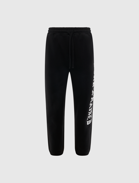 Black streetwear jogger pants with white graphic text on the left leg, drawstring waist