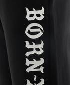 Black streetwear pants with bold white BORN-X lettering on leg