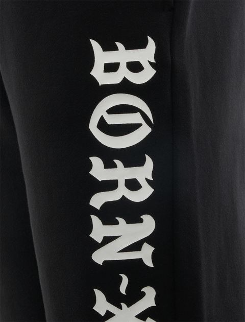 Black streetwear pants with bold white BORN-X lettering on leg