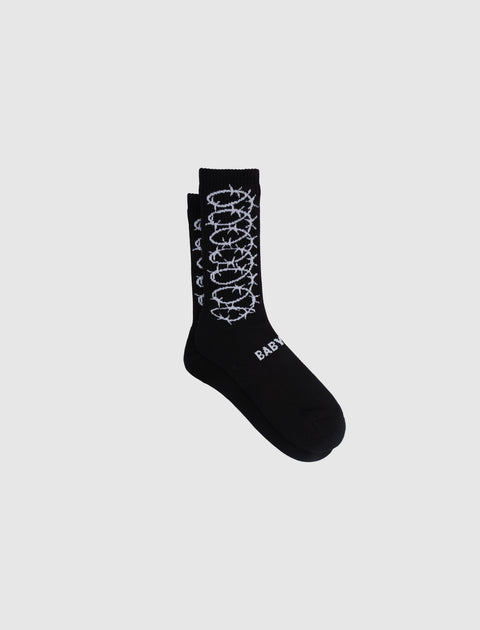 Black crew socks with white barbed wire graphic and text design on the side and foot