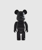 Black bear-shaped collectible figure with articulated arms and legs on a white background
