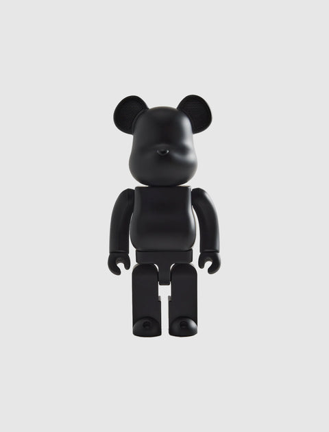 Black bear-shaped collectible figure with articulated arms and legs on a white background