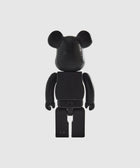 Black bear-shaped collectible toy figure with a perforated face, shown on a white background
