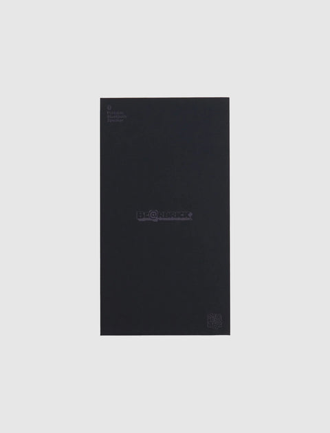 Black Be@rbrick portable Bluetooth speaker box on a plain light background