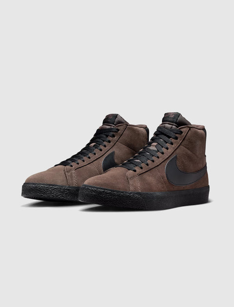 Brown suede high-top sneakers with black Swoosh logo and black soles, side by side on gray background