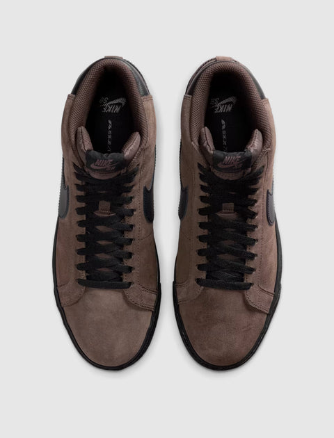 Pair of brown suede low-top sneakers with black laces and black swoosh logo, top view