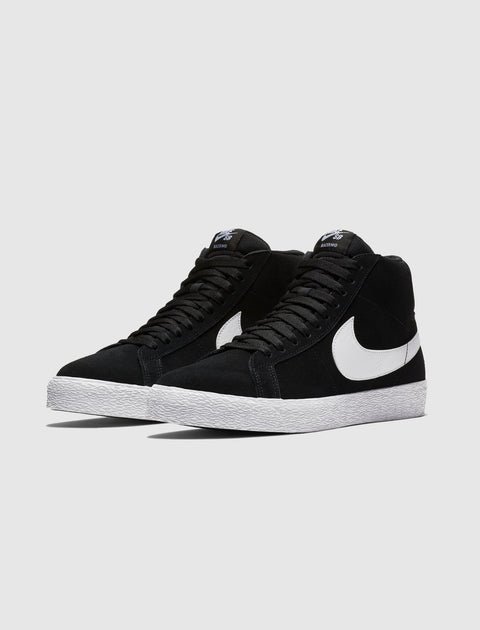 Black and white high-top sneakers with white swoosh and textured white sole on gray background