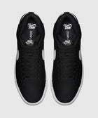 Black and white mid-top sneakers with white swoosh logo, streetwear footwear top view