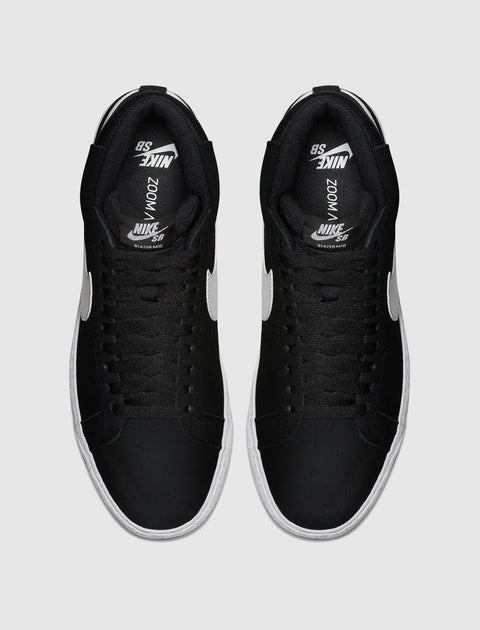 Black and white mid-top sneakers with white swoosh logo, streetwear footwear top view