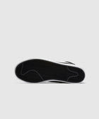Black and white sneaker sole with herringbone tread pattern on a plain background