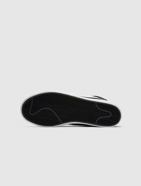 Black and white sneaker sole with herringbone tread pattern on a plain background