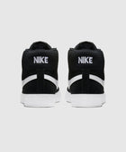 Back view of black and white Nike high-top sneakers with bold branding and textured soles