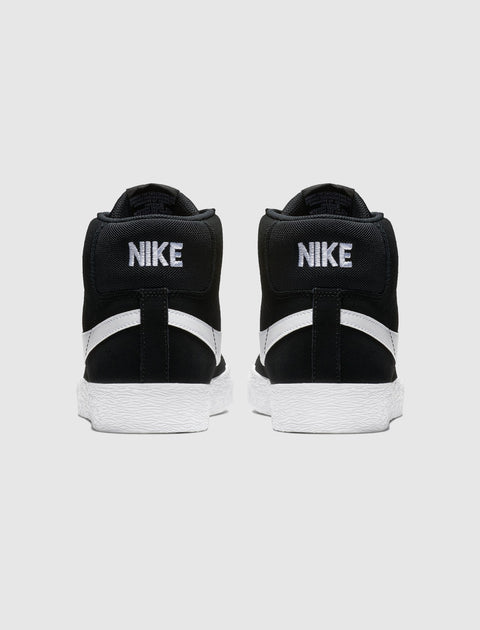 Back view of black and white Nike high-top sneakers with bold branding and textured soles