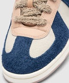 Close-up of men's blue and beige textured sneaker with thick laces and suede details